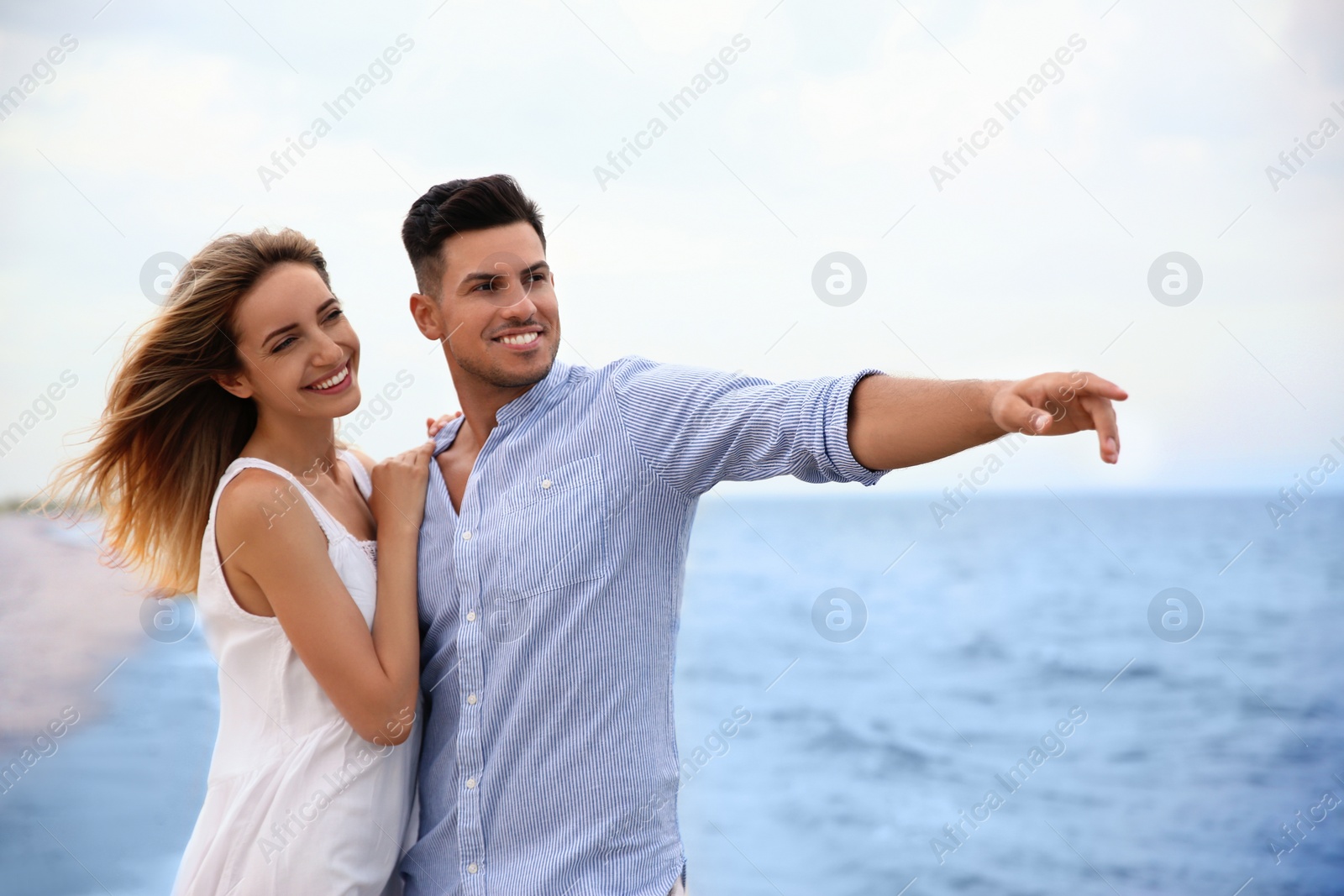 Photo of Happy couple on sea beach. Romantic walk