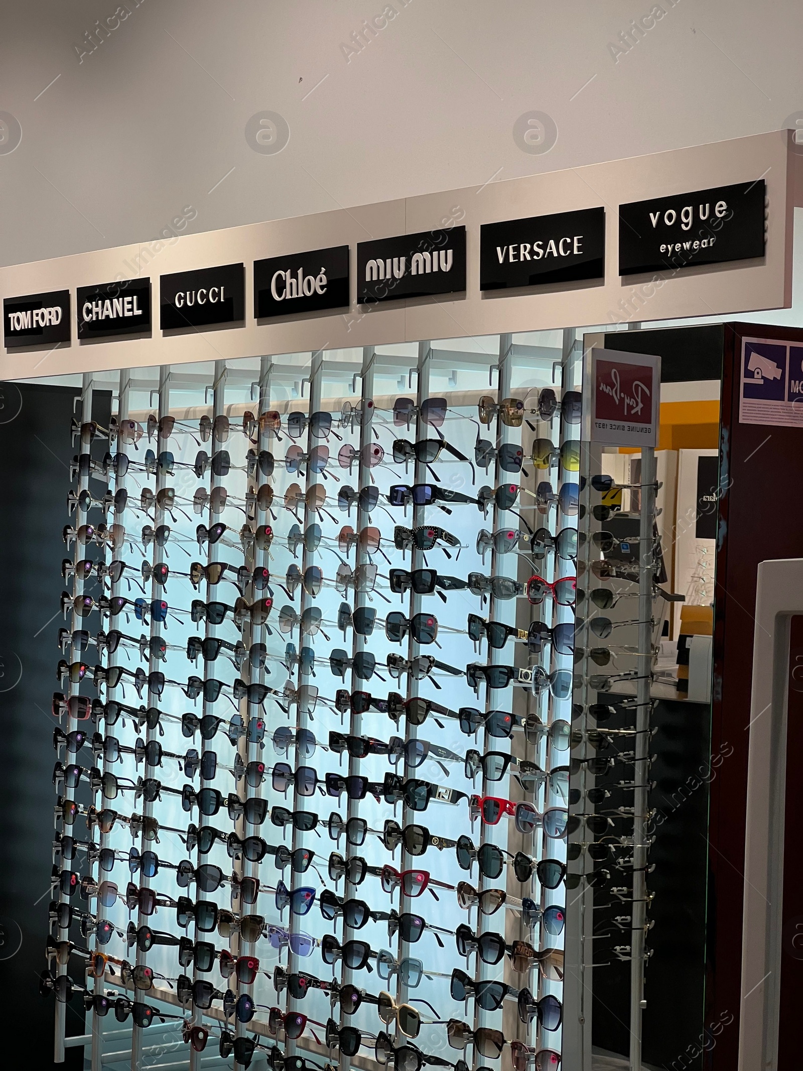 Photo of Poland, Warsaw - July 12, 2022: Many stylish sunglasses from popular brands on racks in shopping mall