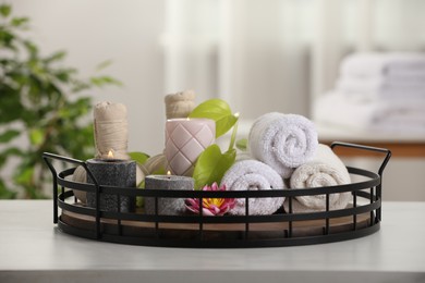 Photo of Composition with different spa products and burning candles on white table indoors