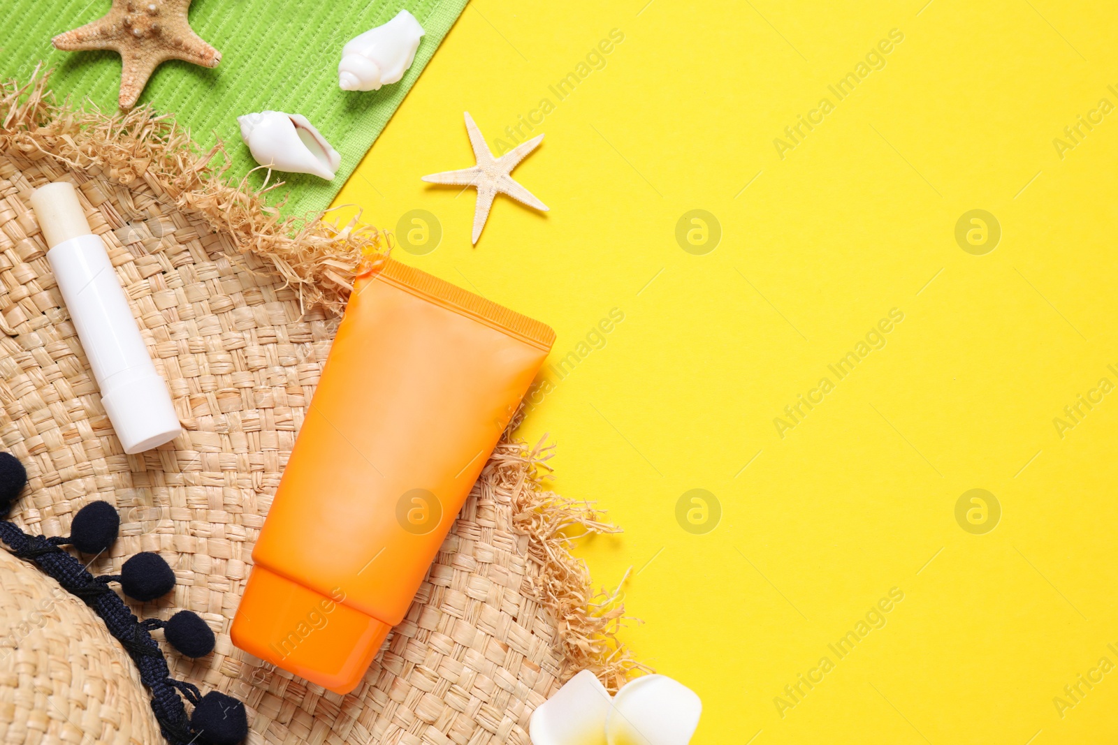 Photo of Flat lay composition with sun protection products on yellow background. Space for text