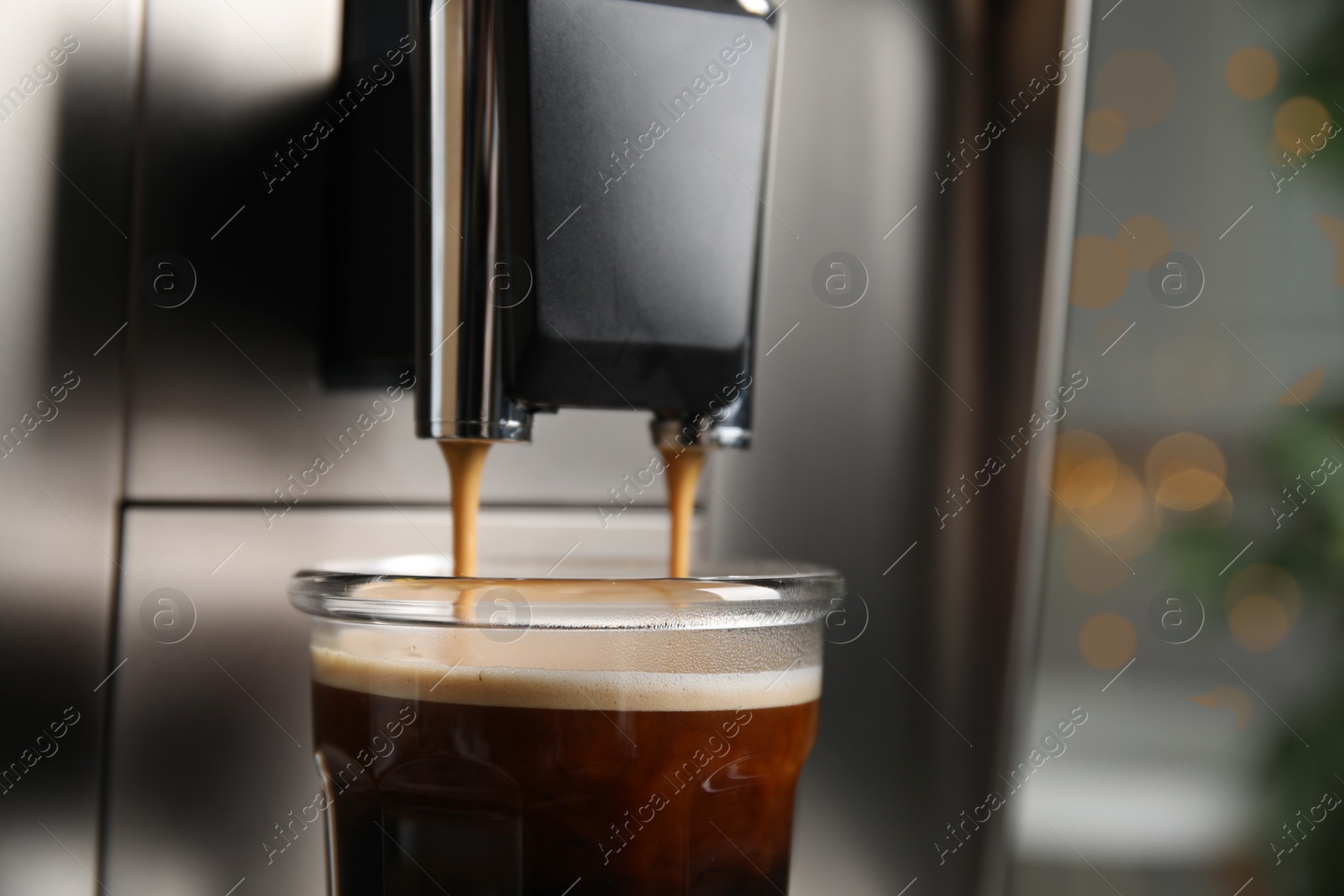 Photo of Espresso machine pouring coffee into glass against blurred background, closeup. Space for text