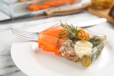 Photo of Delicious aspic with meat and vegetables served on white marble table, closeup