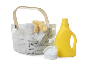 Photo of Detergents and children's clothes on white background