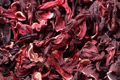 Photo of Dry hibiscus tea as background, closeup view