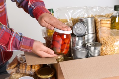 Photo of Man taking food out from donation box, closeup