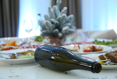 Photo of Dirty dishes on white table in room after new year party, closeup