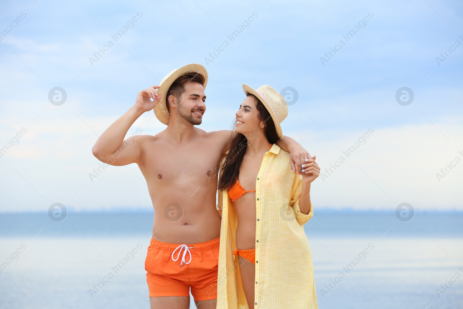 Photo of Happy young couple walking together on beach