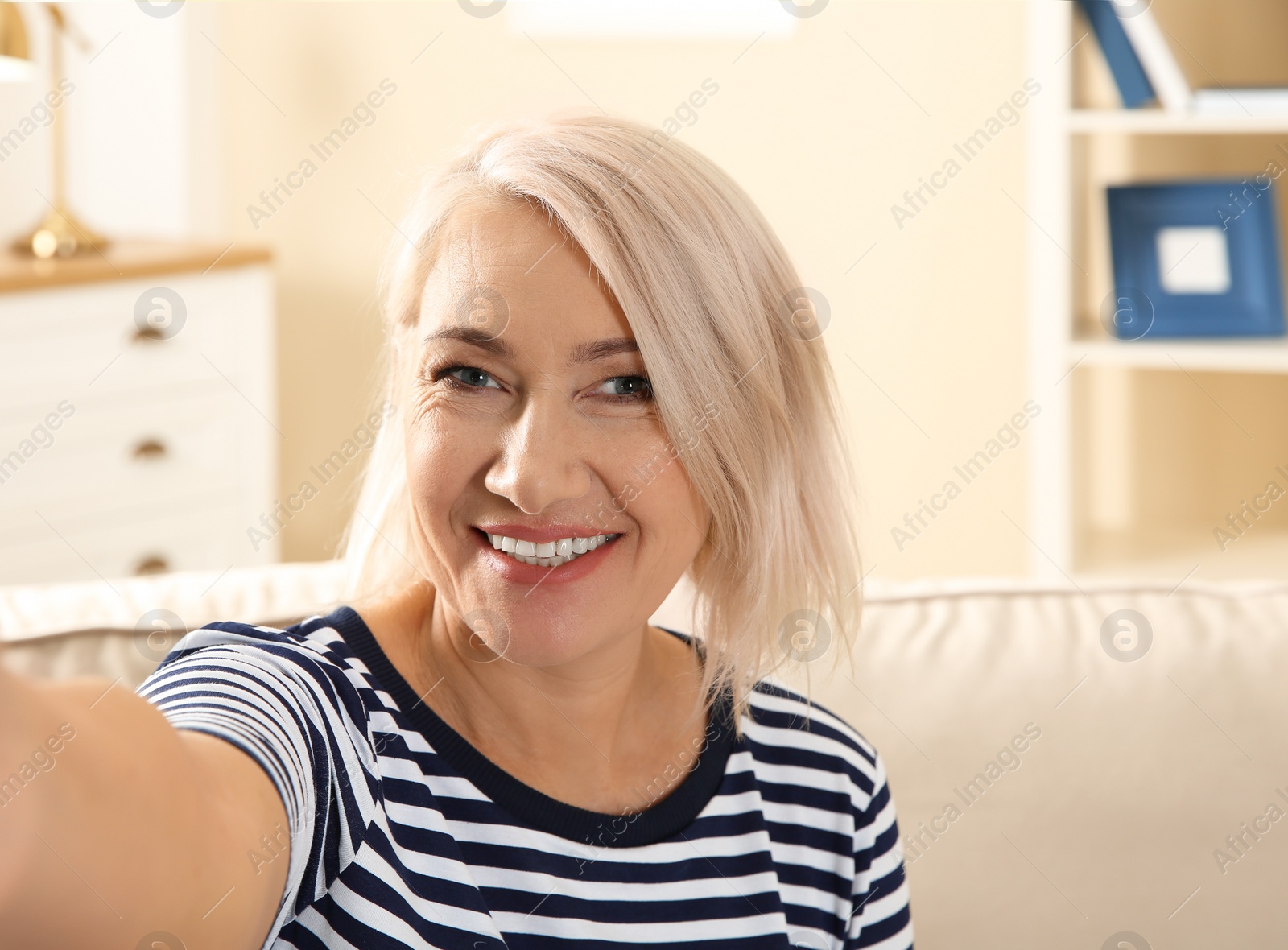 Photo of Mature woman using video chat at home, view from web camera