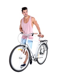 Handsome young hipster man with bicycle on white background