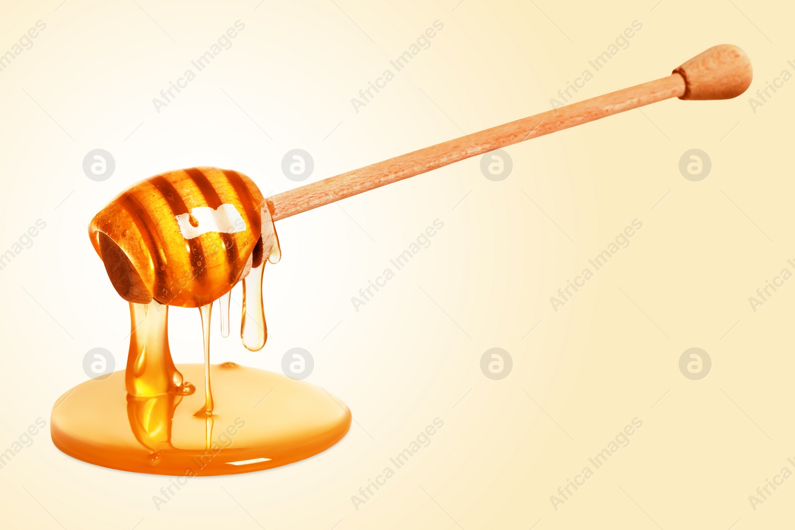 Image of Natural honey dripping from dipper on beige background