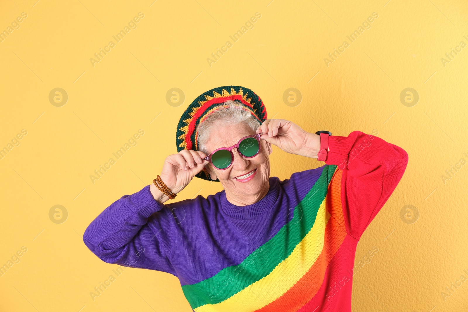 Photo of Portrait of cool grandmother on color background