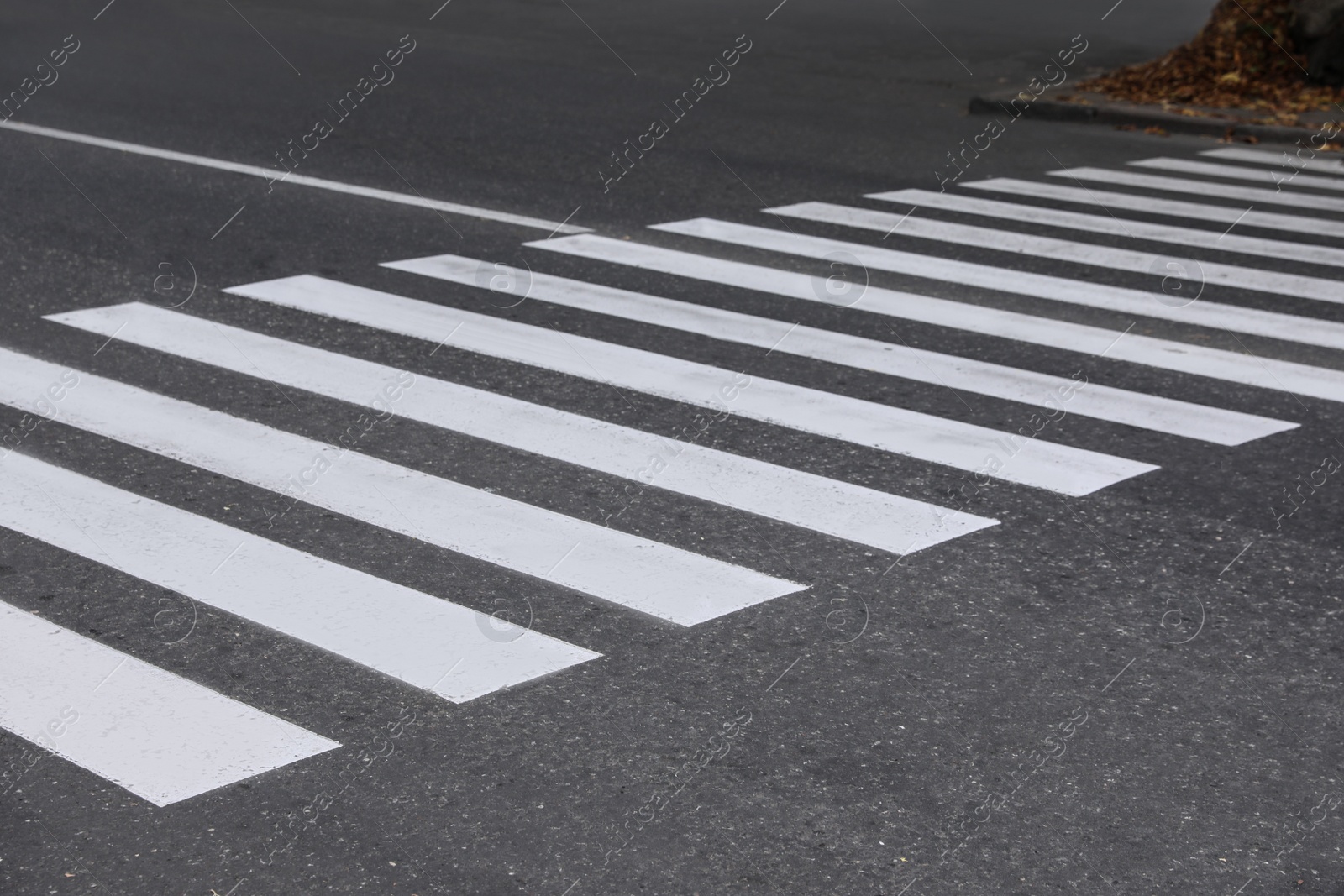 Photo of White pedestrian crossing on empty city street