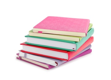 Photo of Stack of colorful notebooks isolated on white. School stationery