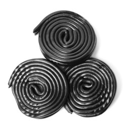 Photo of Tasty black liquorice candies on white background, top view
