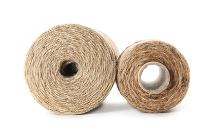 Spools of hemp rope on white background