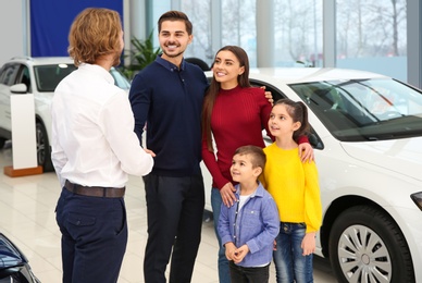Photo of Car salesman working with family in dealership