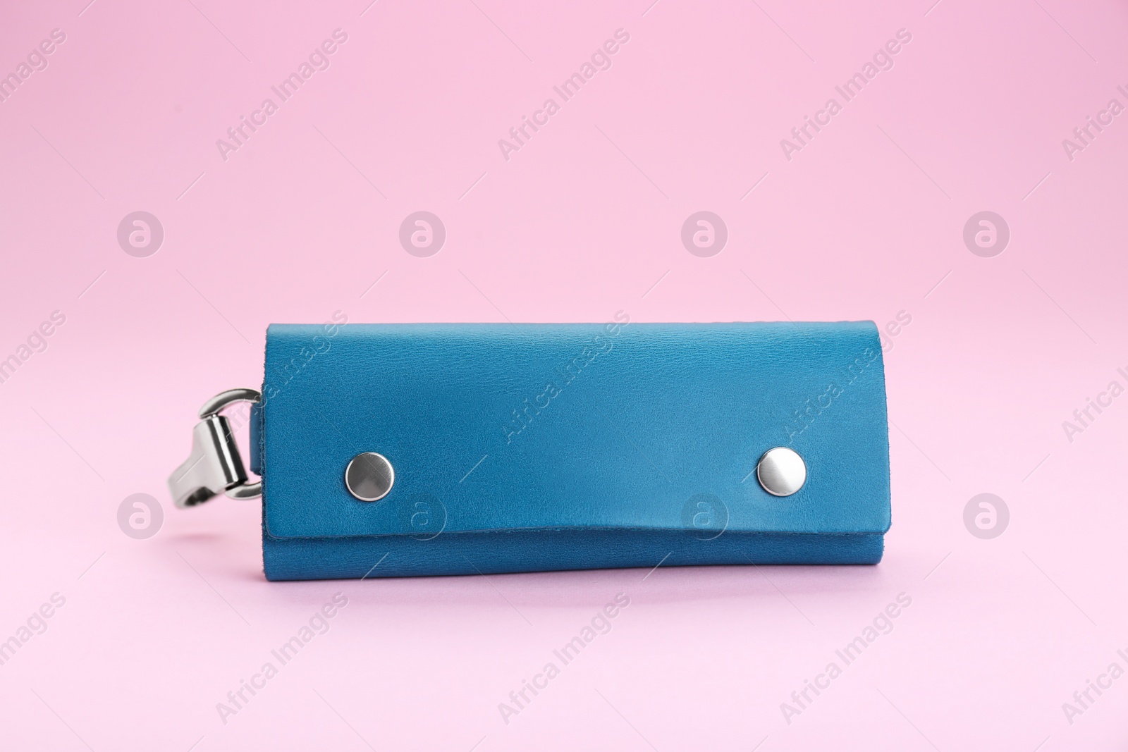 Photo of Stylish leather keys holder on pink background