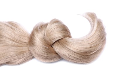 Beautiful strand of blonde hair tied in knot on white background, top view