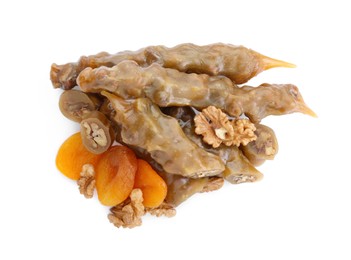 Photo of Delicious sweet churchkhelas with walnuts and dried apricots isolated on white, top view