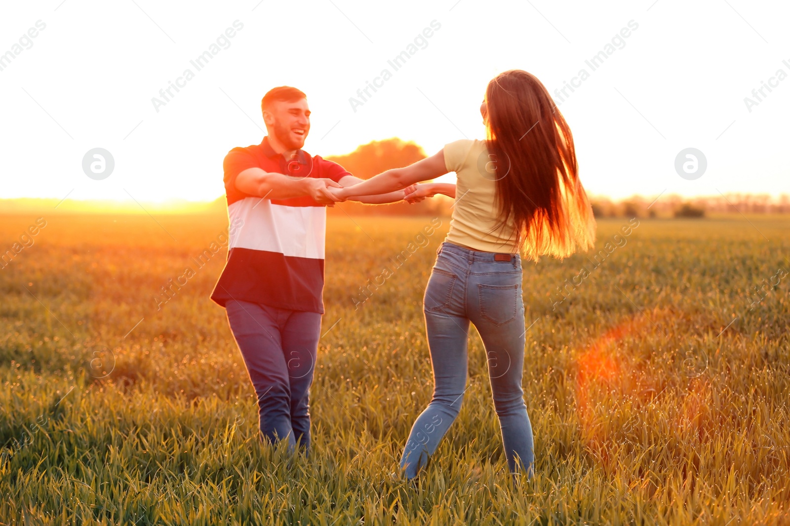 Photo of Happy young couple in green field on sunny spring day