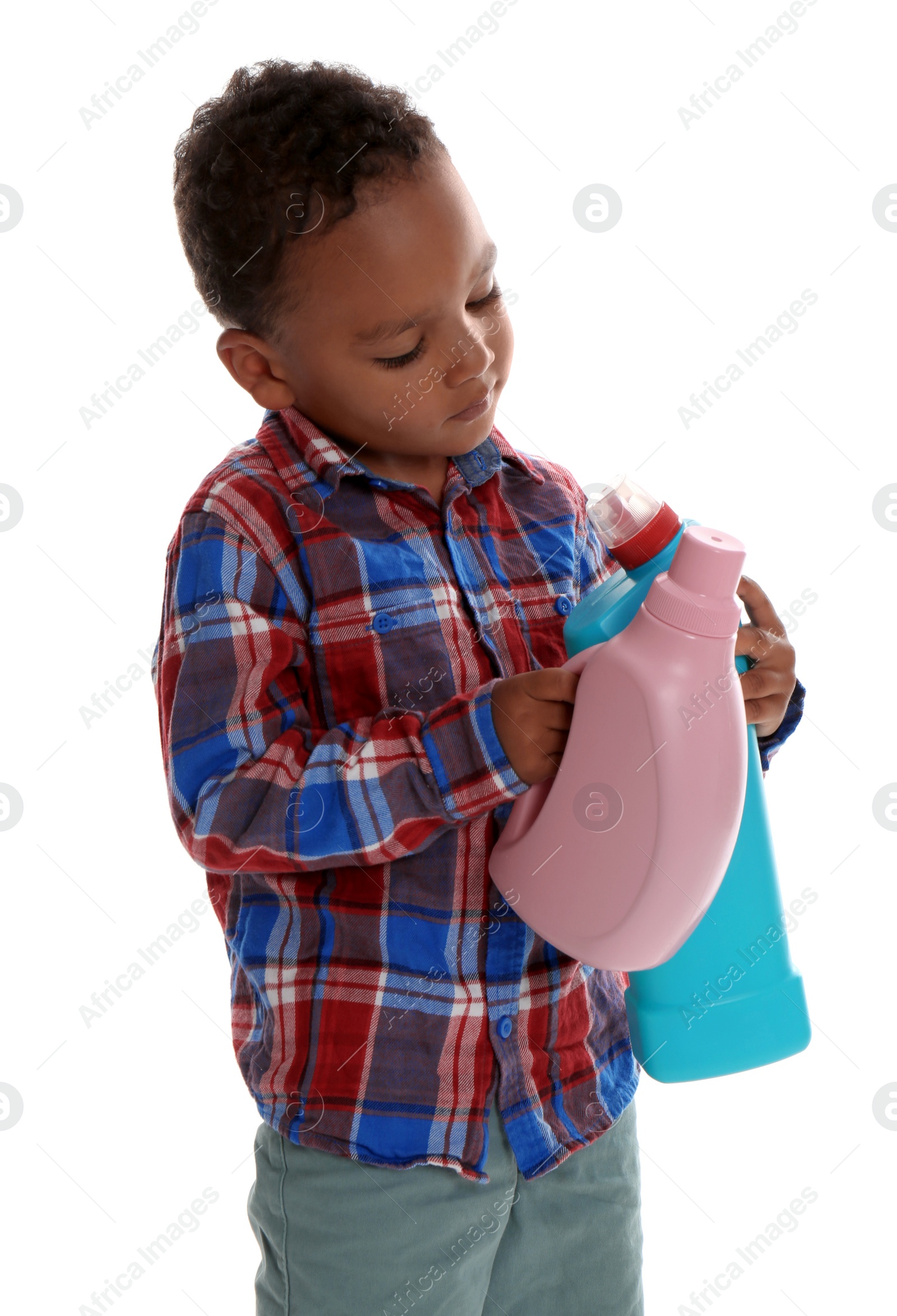 Photo of Little African-American boy playing with detergents on white background. Danger at home