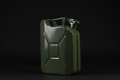 Photo of New khaki metal canister on black background