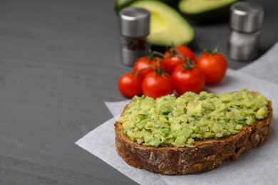 Photo of Delicious sandwich with guacamole on gray table, closeup