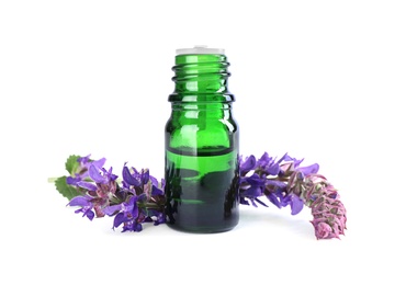 Bottle of herbal essential oil and sage flowers isolated on white