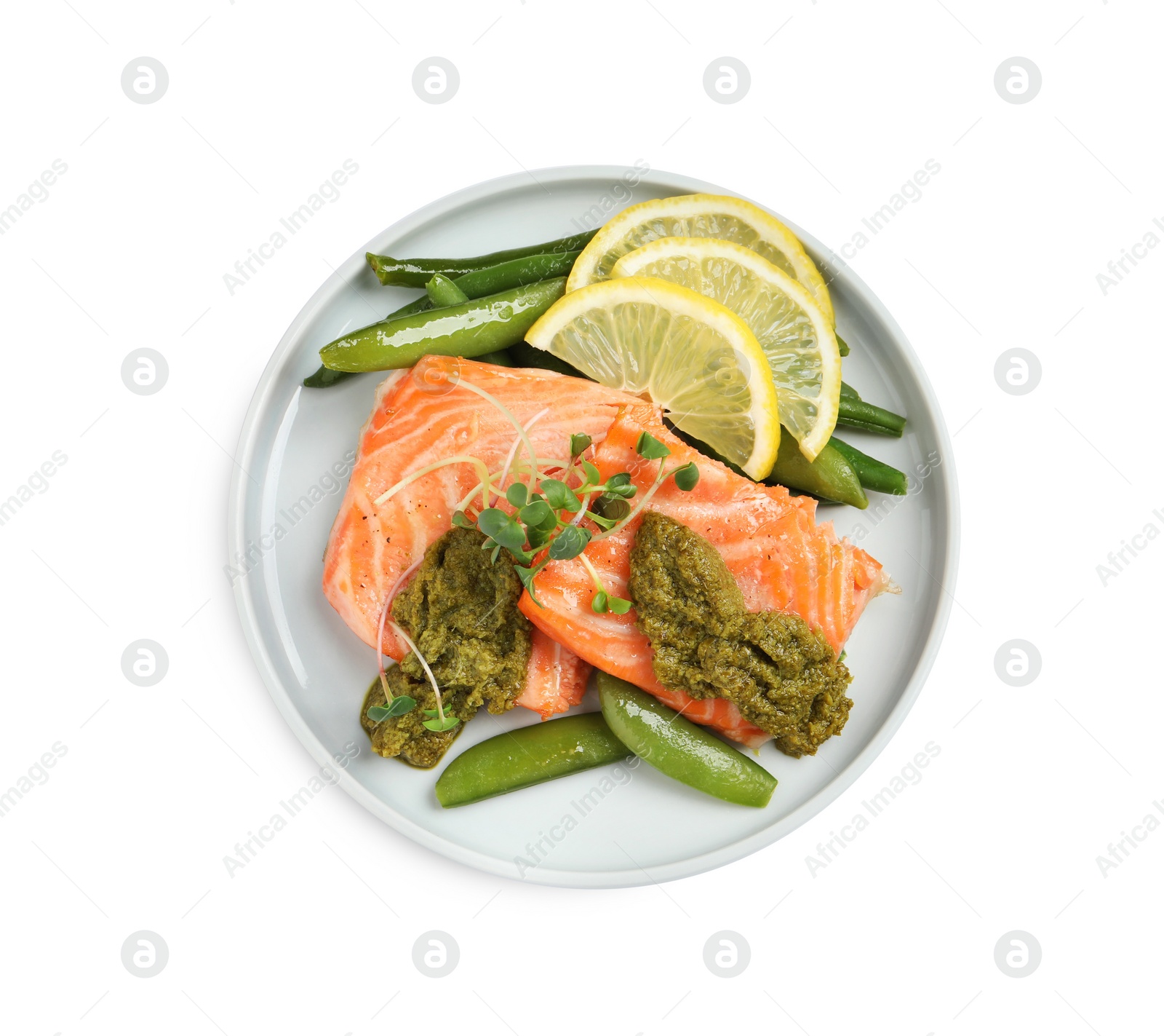 Photo of Tasty cooked salmon with pesto sauce on white background, top view