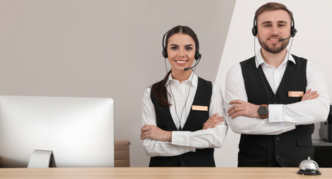 Image of Young receptionists in uniform at workplace. Banner design