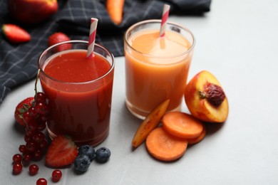 Photo of Delicious juices and fresh ingredients on grey table