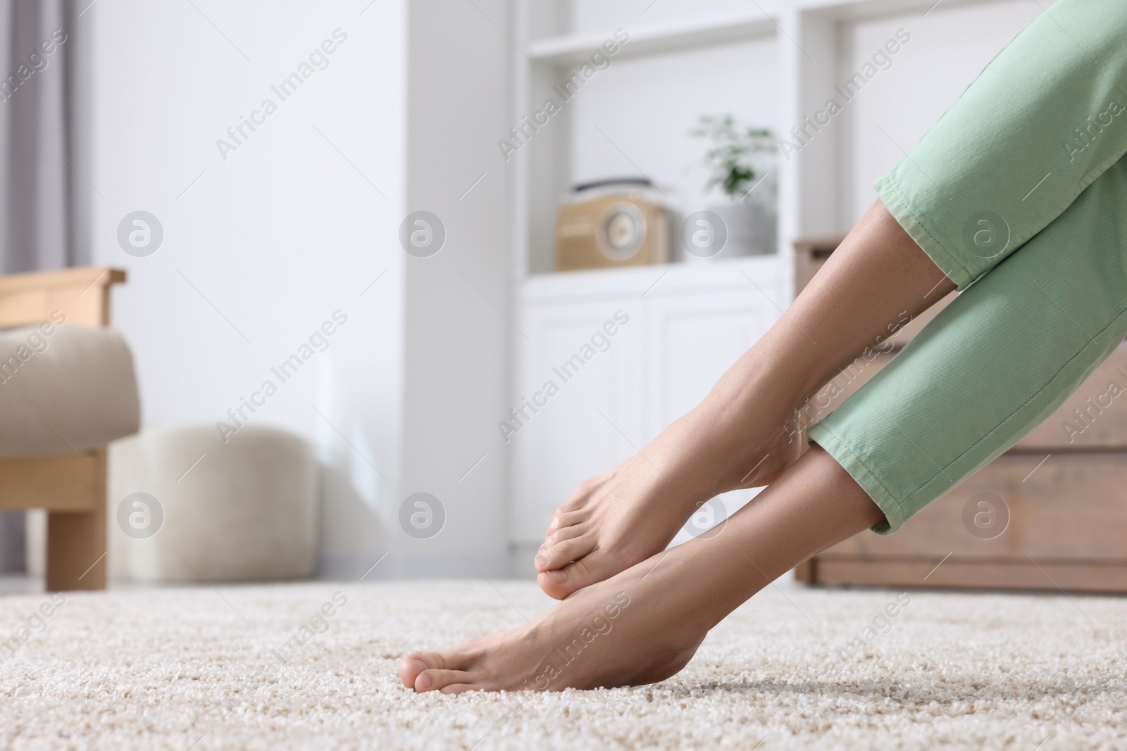 Photo of Woman on soft light brown carpet at home, closeup. Space for text