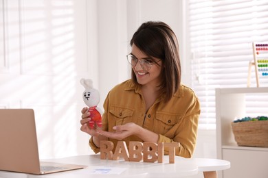 Photo of Happy English teacher giving online lesson. Early childhood education