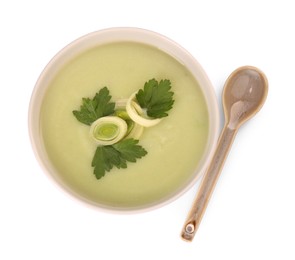 Photo of Bowl of delicious leek soup and spoon isolated on white, top view