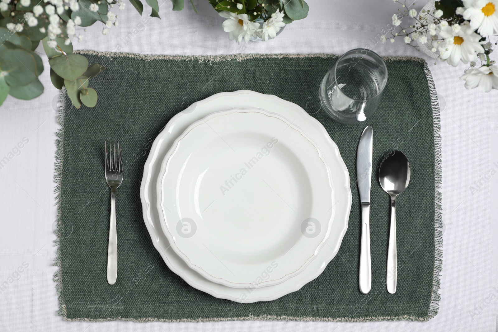 Photo of Elegant festive setting with floral decor on table, flat lay