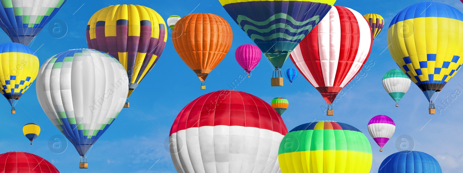 Image of Many bright hot air balloons flying in sky, banner design