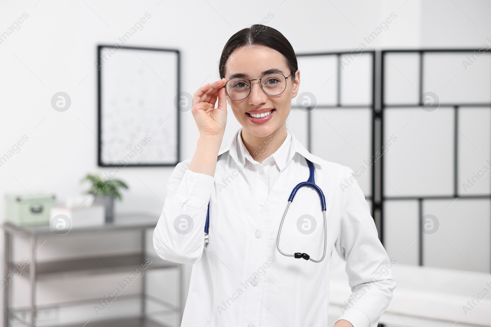 Photo of Medical consultant with glasses and stethoscope in clinic