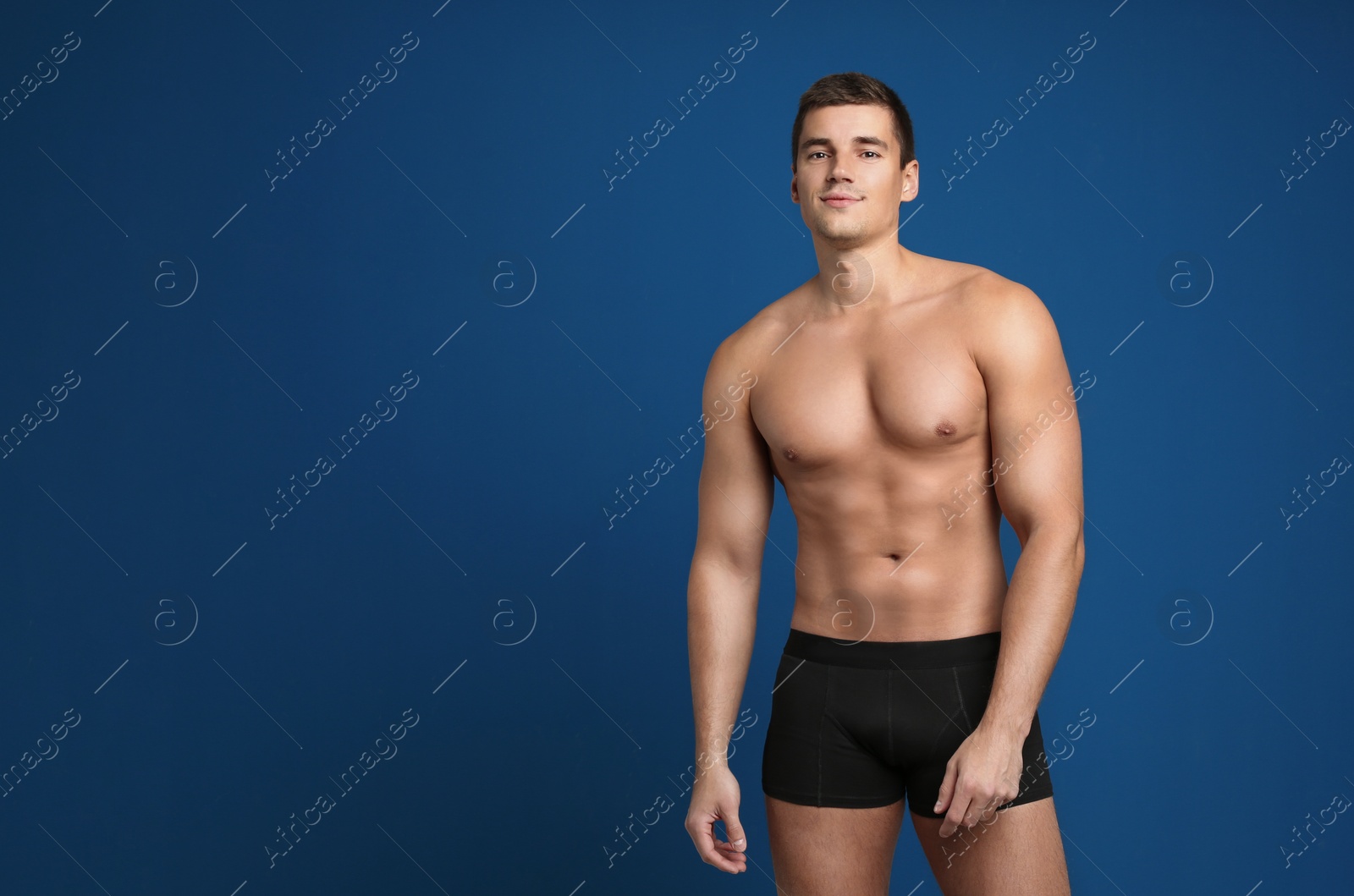 Photo of Man with sexy body on blue background