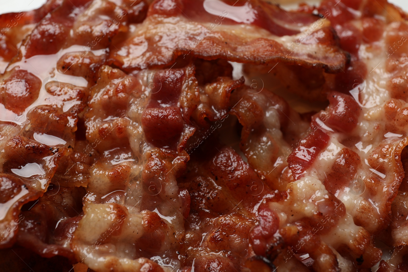 Photo of Slices of tasty fried bacon as background, closeup