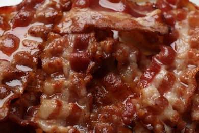 Slices of tasty fried bacon as background, closeup