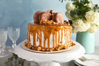 Dessert stand with delicious caramel cake, closeup