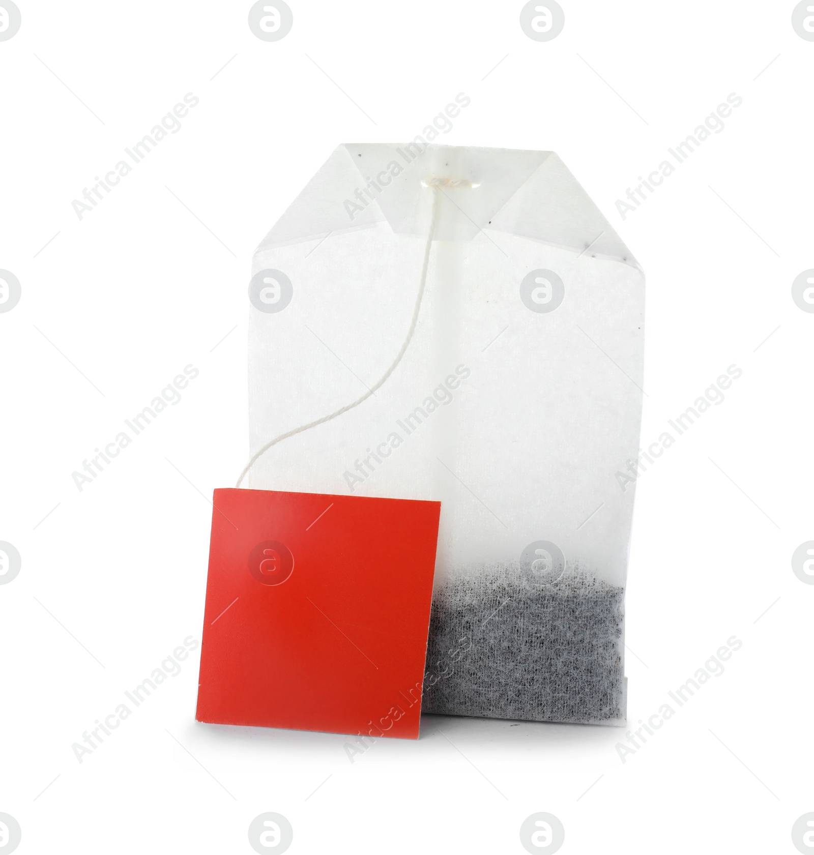 Photo of Unused tea bag with tag on white background. Space for text