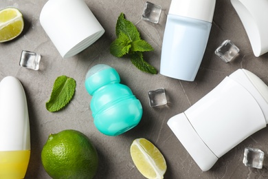 Photo of Flat lay composition with female roll-on deodorants on grey table