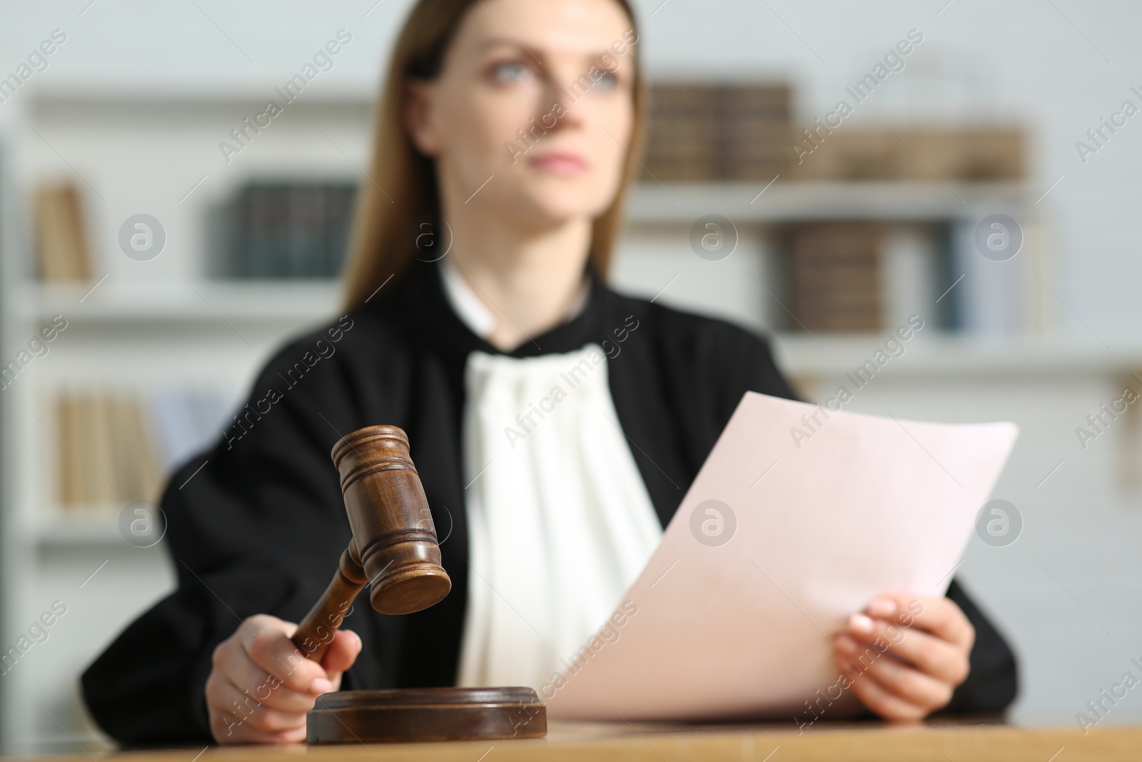 Photo of Judge striking mallet at table indoors, selective focus