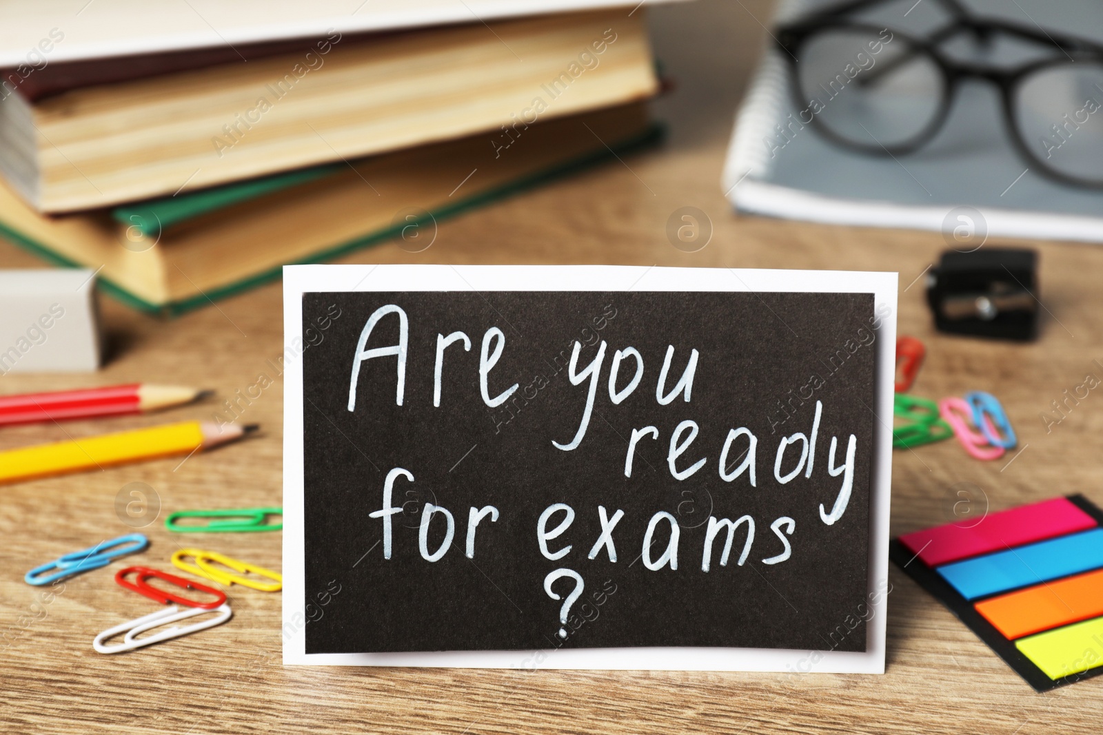 Photo of Card with question Are You Ready For Exams? on wooden table