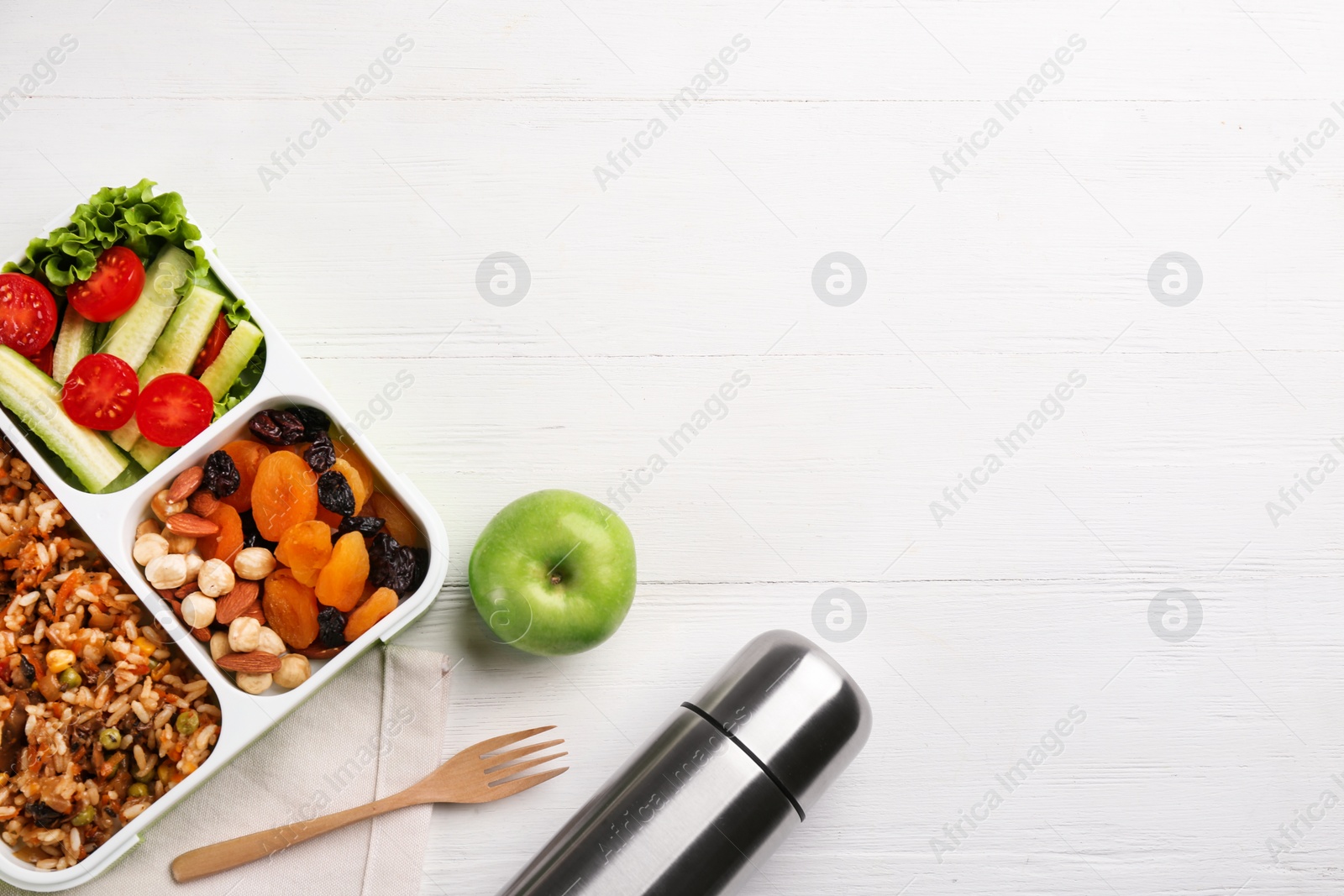 Photo of Thermos and lunch box on white wooden background, flat lay. Space for text