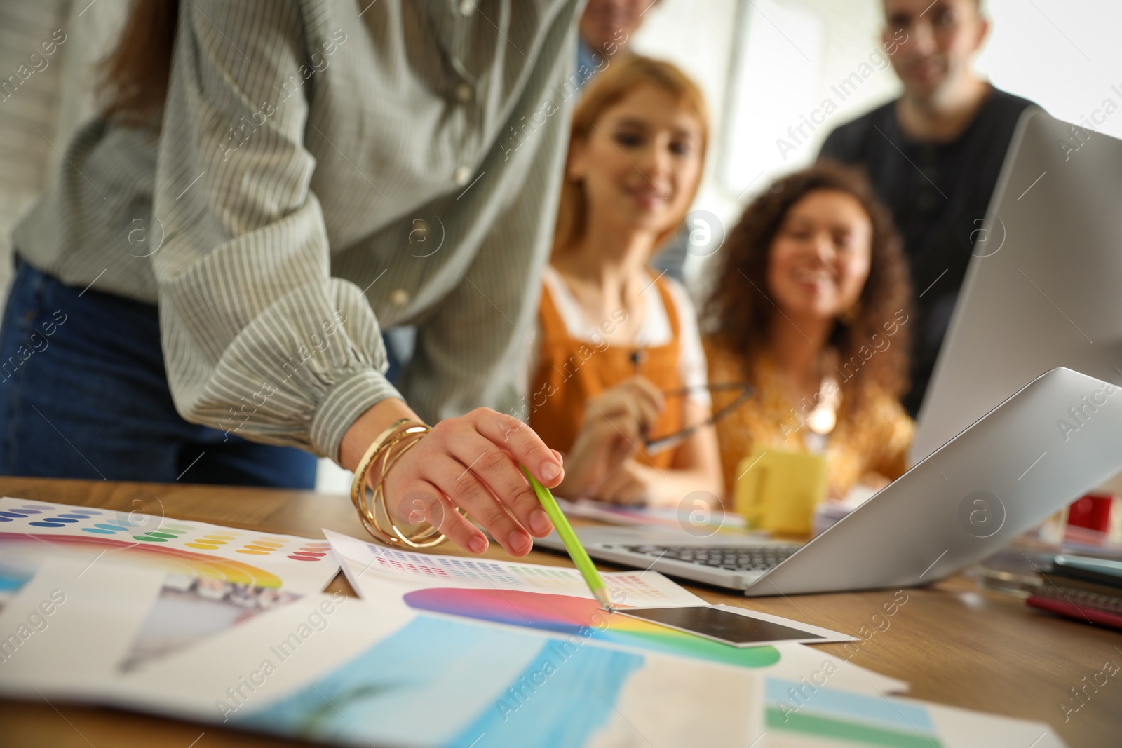 Photo of Team of professional designers working in office, closeup