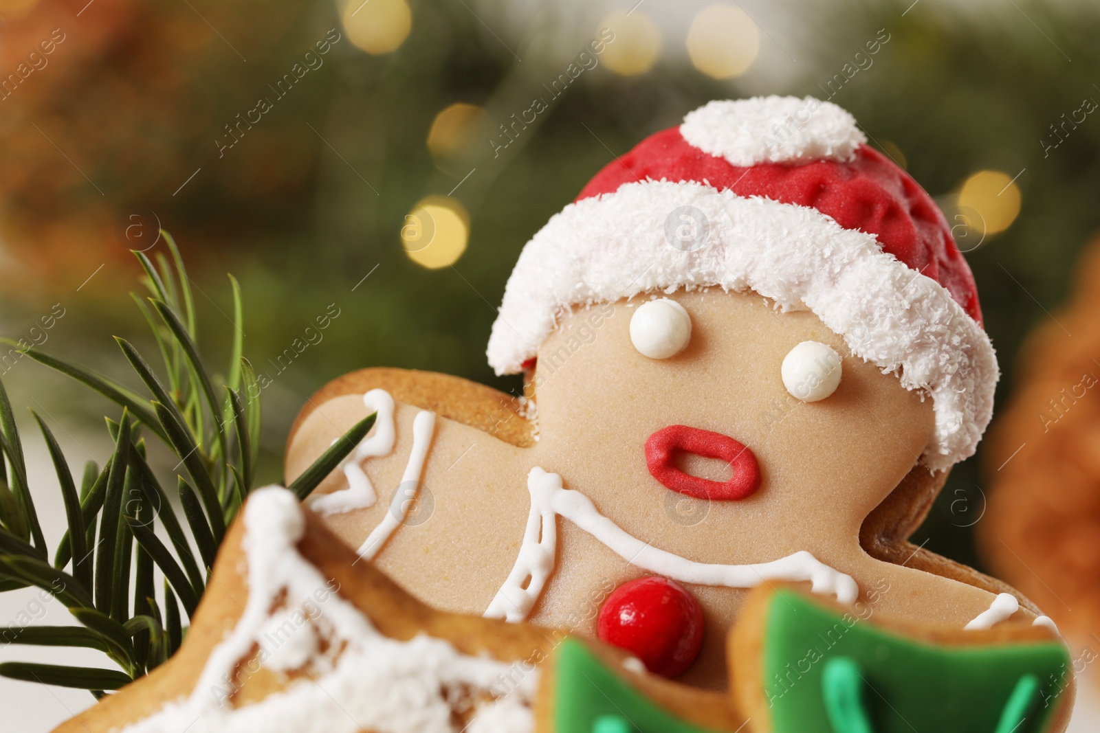 Photo of Delicious homemade Christmas cookies against blurred festive lights, closeup