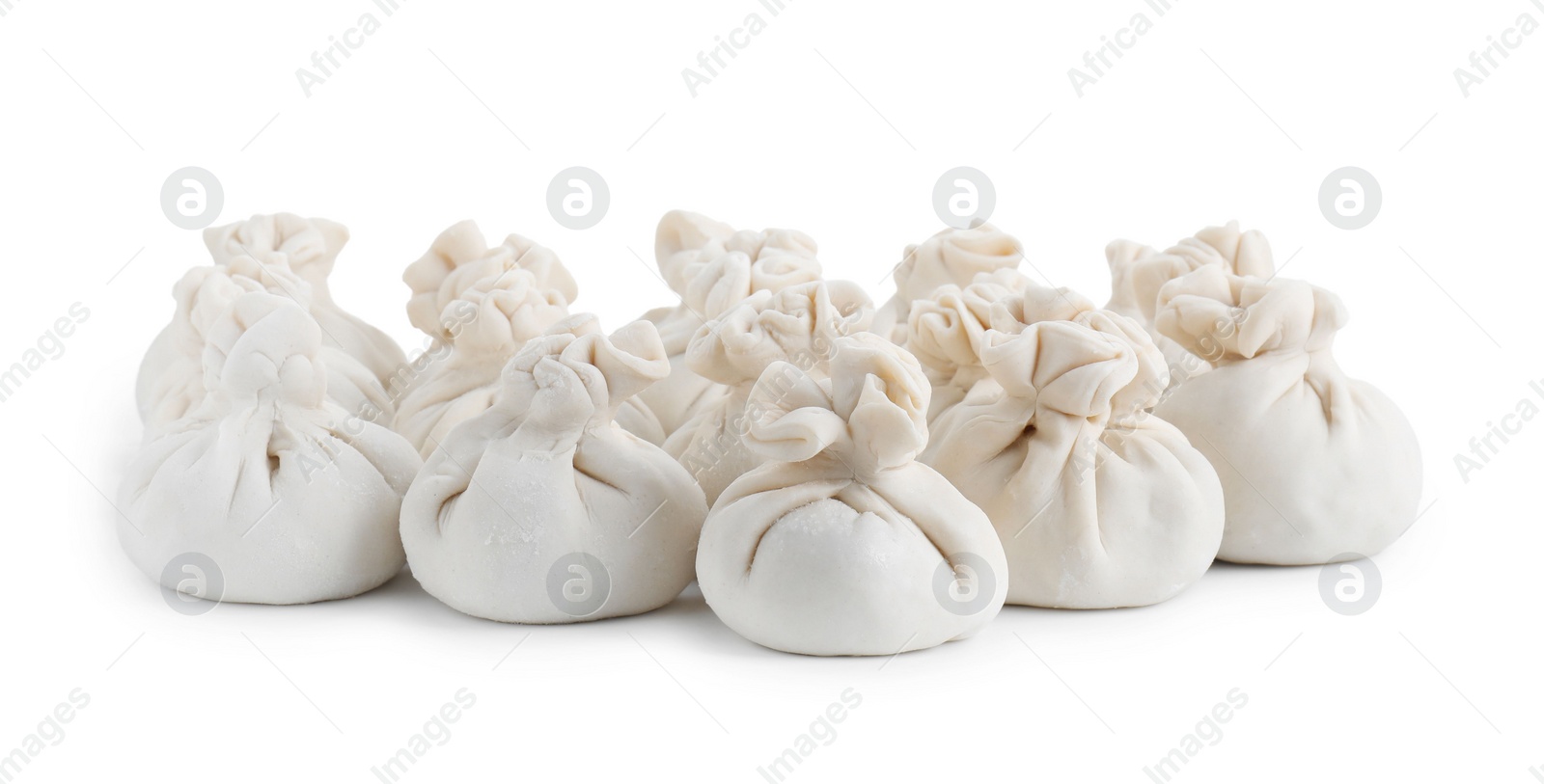 Photo of Many uncooked khinkali (dumplings) isolated on white. Georgian cuisine