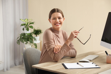 Photo of Professional psychotherapist at table in modern office